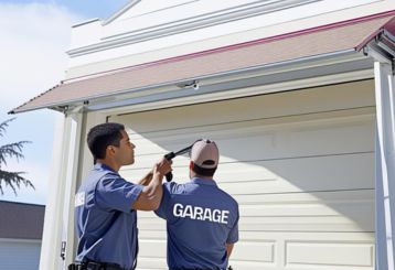 Technicians installing a new residential garage door in Cedar Park, Texas