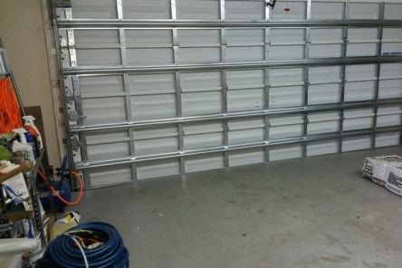 Technician’s tools and equipment used for realigning garage door tracks and rollers in a Cedar Park garage