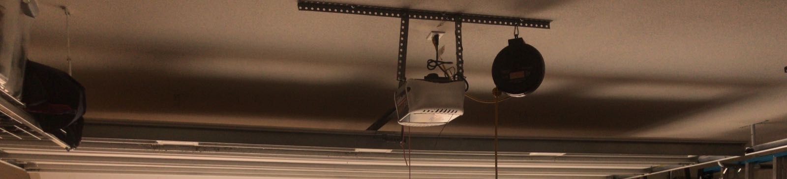 Garage interior with open door and technician's vehicle in driveway
