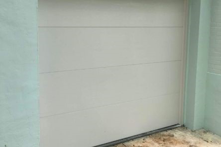 Newly installed modern white sectional garage door on Round Rock home.