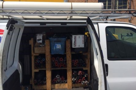 Service van with garage door repair tools and replacement rollers for Leander, TX project