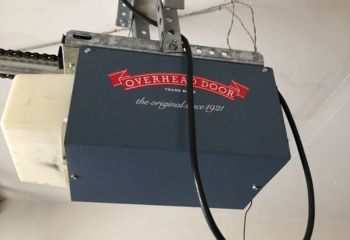 Close-up of Overhead Door opener installed and powered on in a residential Cedar Park garage.
