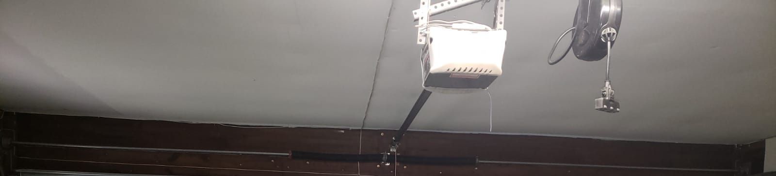 Full view of repaired garage door and opener system after service in Cedar Park, TX.
